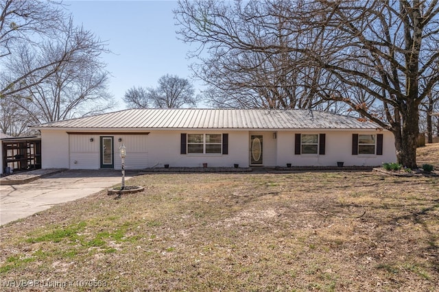 ranch-style house featuring a front yard and metal roof