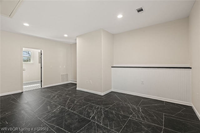 empty room featuring recessed lighting, visible vents, marble finish floor, and baseboards