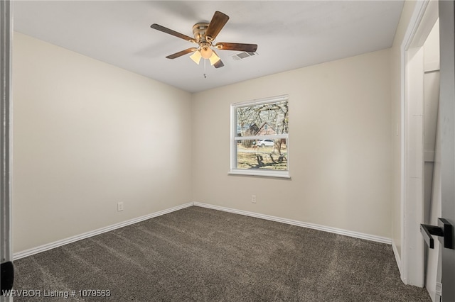 unfurnished room featuring baseboards, visible vents, dark carpet, and ceiling fan