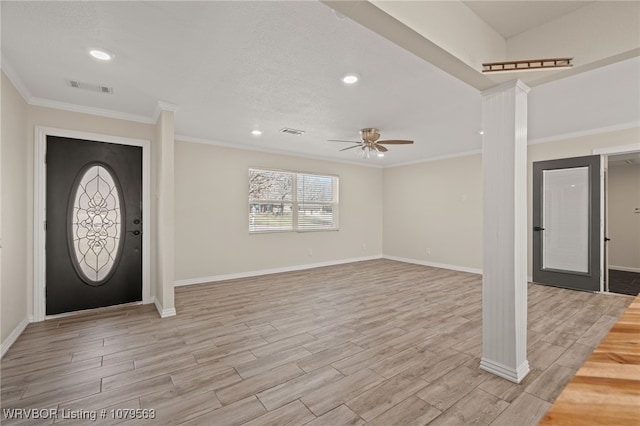 foyer featuring ornamental molding, visible vents, and light wood-type flooring