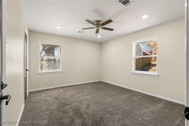 empty room with recessed lighting, baseboards, visible vents, and dark carpet