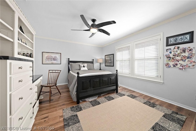 bedroom with hardwood / wood-style floors, crown molding, and ceiling fan