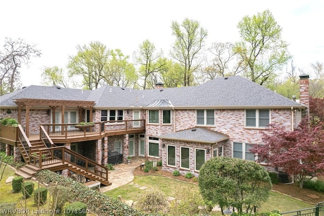 back of property featuring a wooden deck, a pergola, a patio area, and a yard