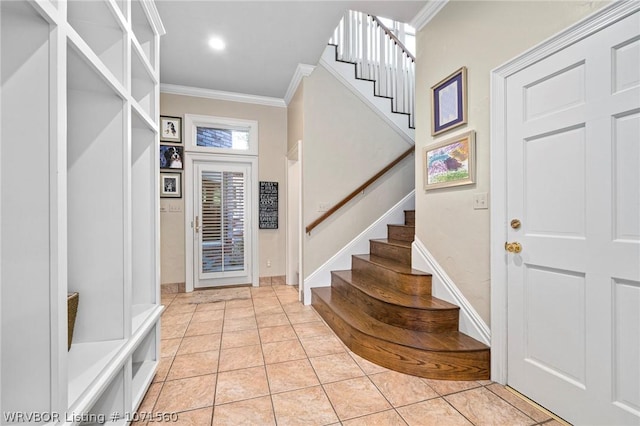 tiled entryway featuring ornamental molding