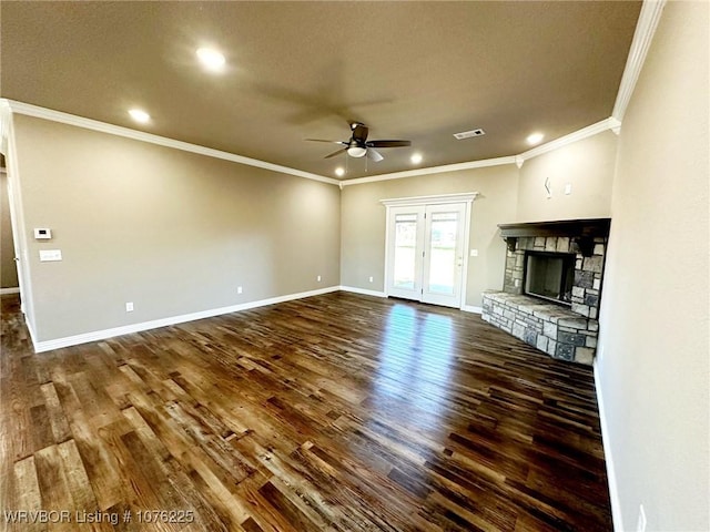 unfurnished living room with ceiling fan, ornamental molding, a fireplace, and dark wood-type flooring