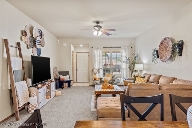 carpeted living room with ceiling fan