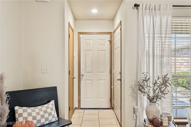 doorway to outside featuring light tile patterned flooring