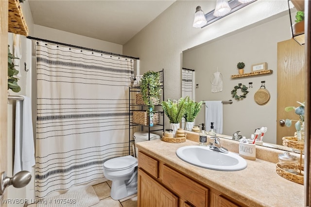 bathroom with toilet, vanity, tile patterned floors, and a shower with shower curtain