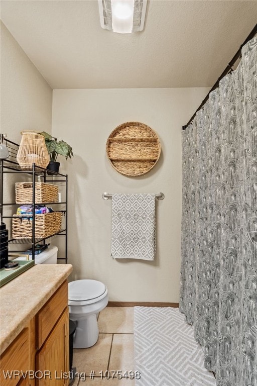 bathroom featuring tile patterned floors, vanity, and toilet