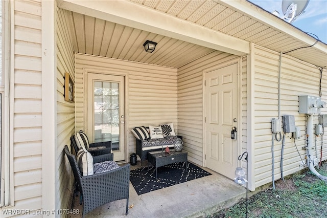 entrance to property featuring an outdoor hangout area and a patio