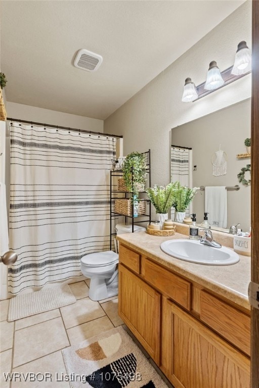 bathroom with tile patterned floors, vanity, and toilet