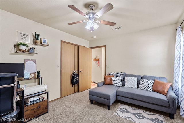 carpeted living room with ceiling fan