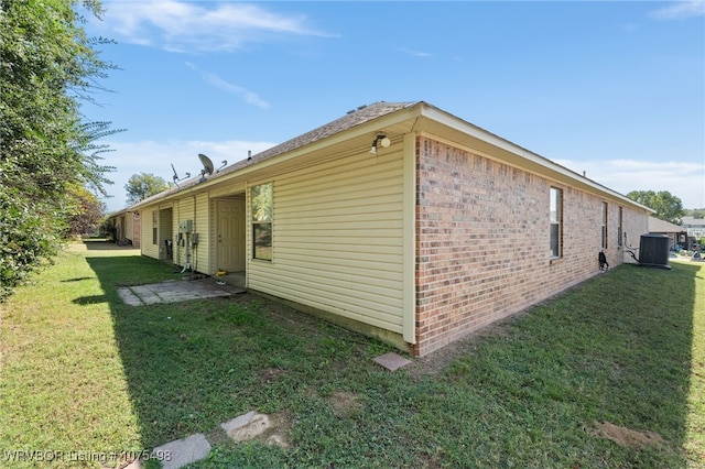 view of property exterior featuring a lawn and central air condition unit