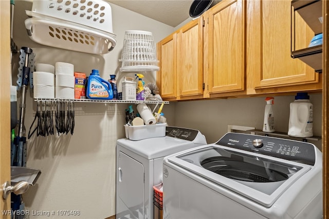 laundry room with cabinets, separate washer and dryer, and a textured ceiling