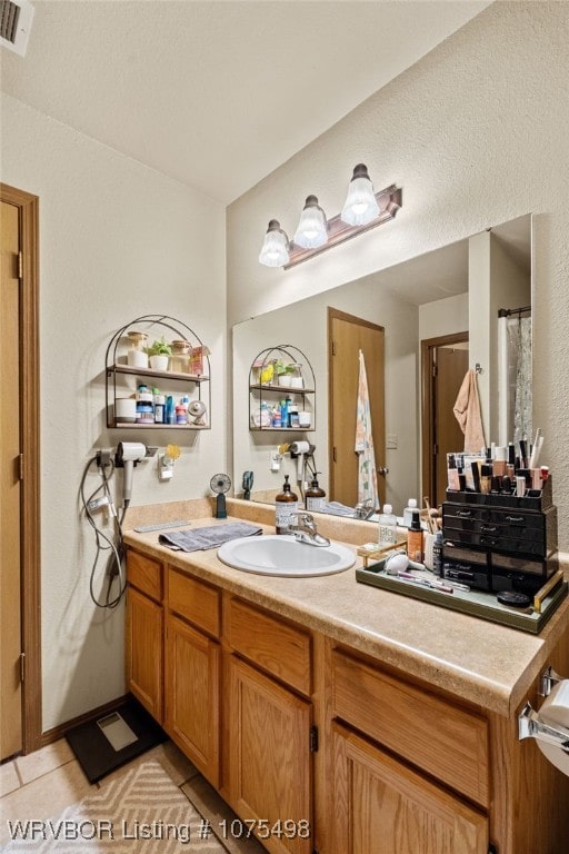 bathroom featuring tile patterned floors and vanity