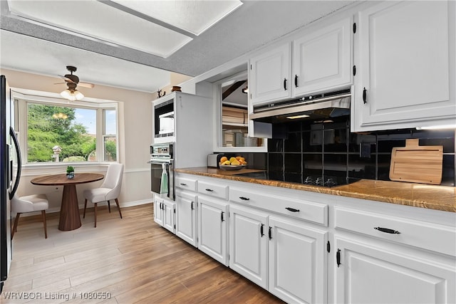 8611 Royal Ridge Dr, Fort Smith, AR 72903 - kitchen featuring wall oven, under cabinet range hood, white cabinets, and black electric cooktop