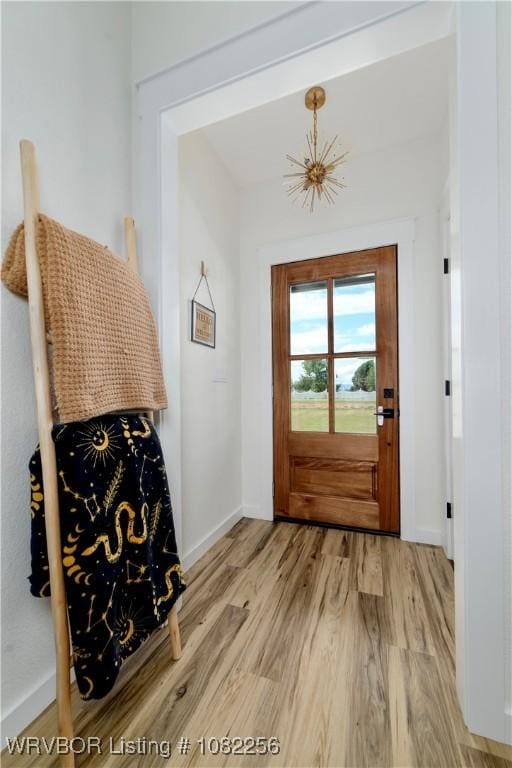 16312 Castle Rd, Poteau, OK 74953 - doorway to outside featuring wood finished floors and baseboards