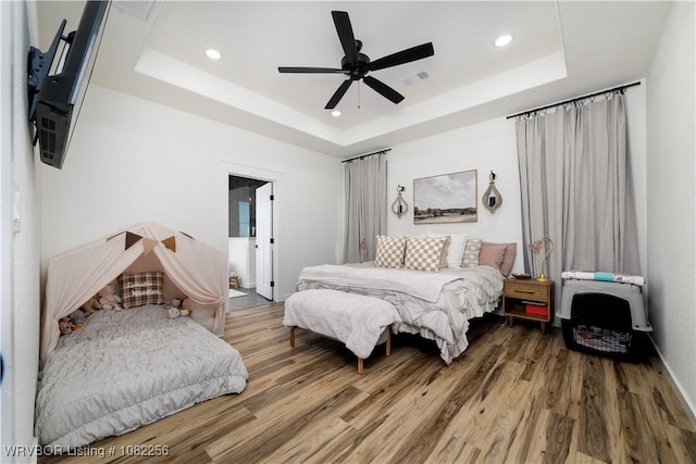 16312 Castle Rd, Poteau, OK 74953 - bedroom with wood finished floors, a tray ceiling, recessed lighting, and ceiling fan