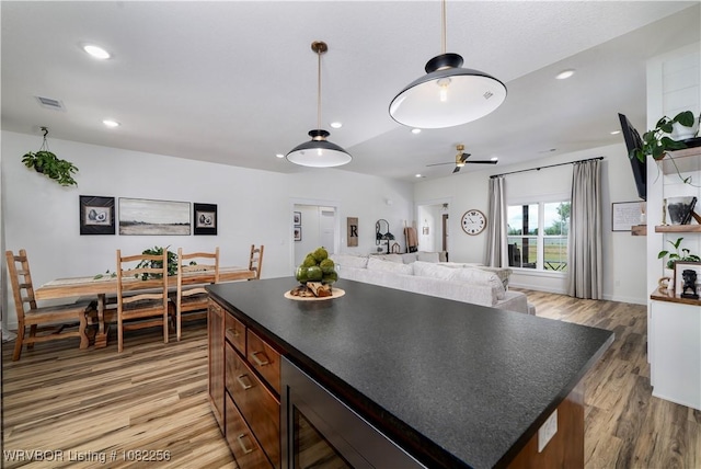 16312 Castle Rd, Poteau, OK 74953 - kitchen with light wood-type flooring, dark countertops, hanging light fixtures, recessed lighting, and open floor plan