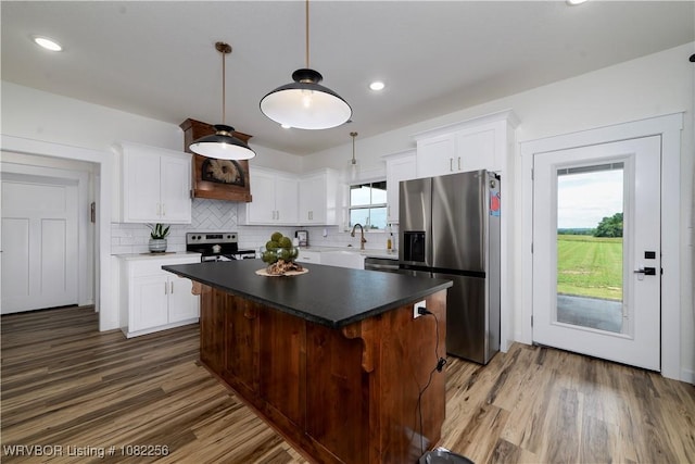 16312 Castle Rd, Poteau, OK 74953 - kitchen featuring stainless steel appliances, dark wood finished floors, a center island, backsplash, and recessed lighting