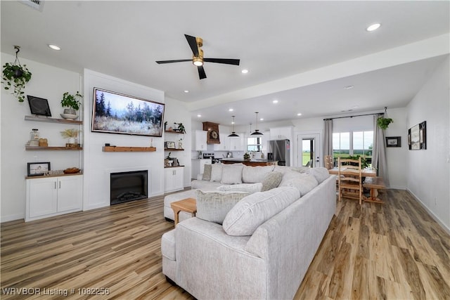 16312 Castle Rd, Poteau, OK 74953 - living area featuring light wood-type flooring, recessed lighting, ceiling fan, and a fireplace