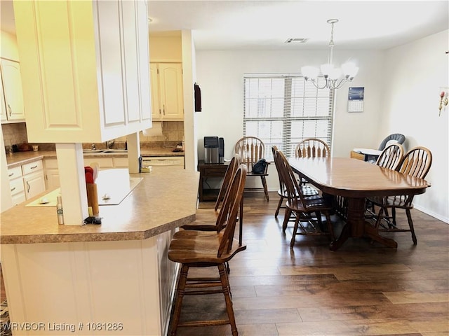 2103 W George, Pocola, OK 74902 - dining area with a chandelier and dark wood finished floors