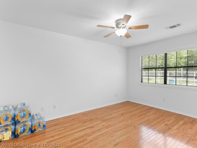 spare room featuring light hardwood / wood-style flooring and ceiling fan