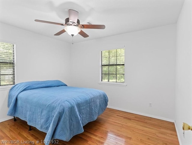 bedroom featuring hardwood / wood-style flooring and ceiling fan