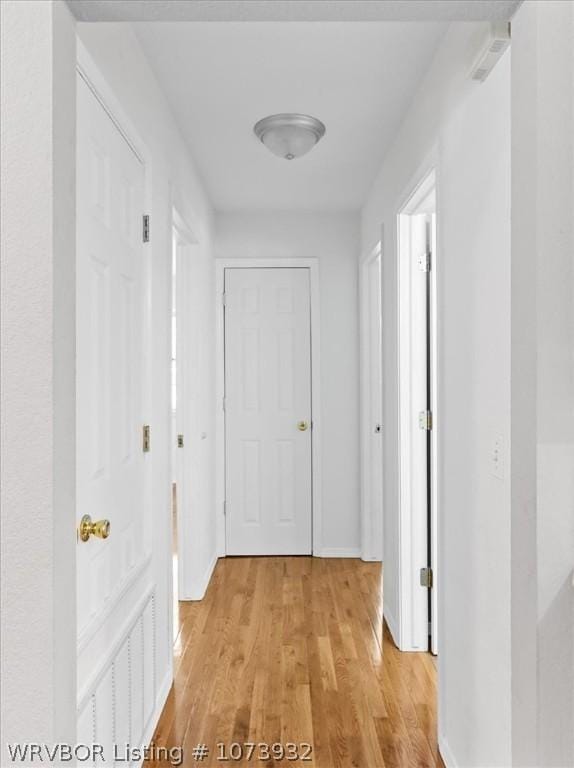 hall with light hardwood / wood-style flooring