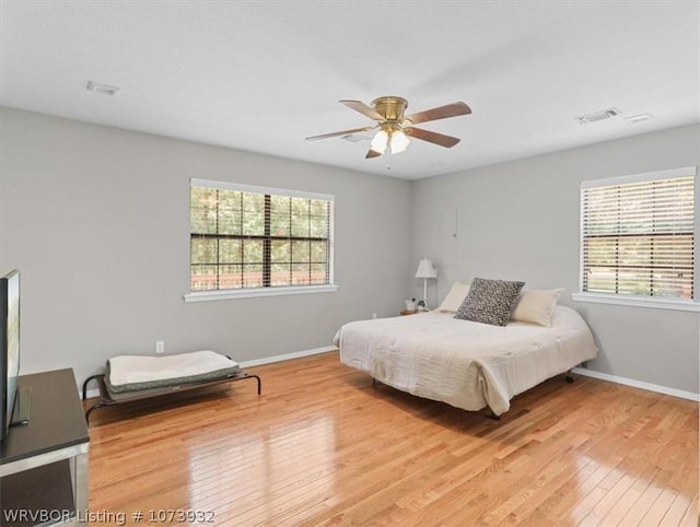 bedroom with ceiling fan and light hardwood / wood-style floors