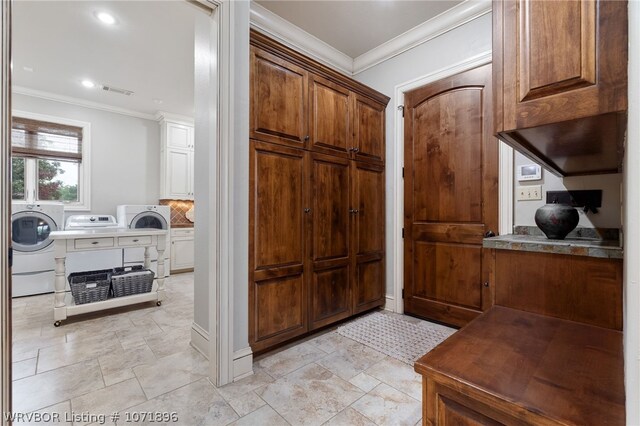 interior space with crown molding and washing machine and clothes dryer