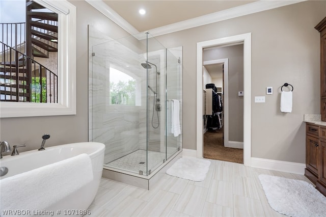 bathroom with vanity, a shower with shower door, and crown molding