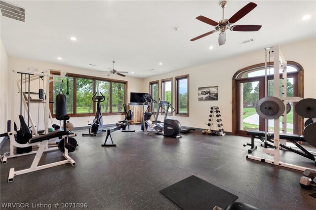 gym with ceiling fan, plenty of natural light, and french doors