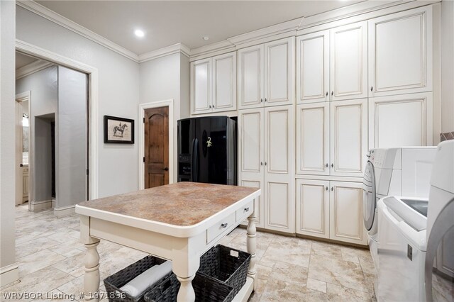 kitchen featuring crown molding, black fridge with ice dispenser, and independent washer and dryer