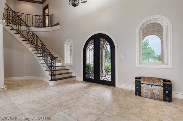 entryway featuring french doors and a high ceiling