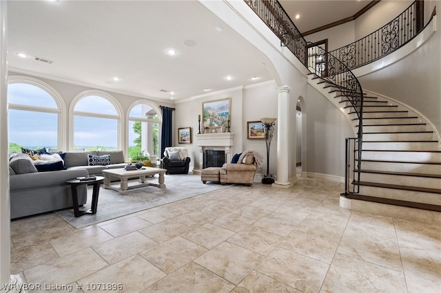 living room featuring ornate columns and crown molding