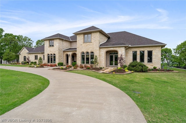 view of front facade featuring a front yard and french doors