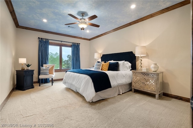 carpeted bedroom featuring ceiling fan and crown molding