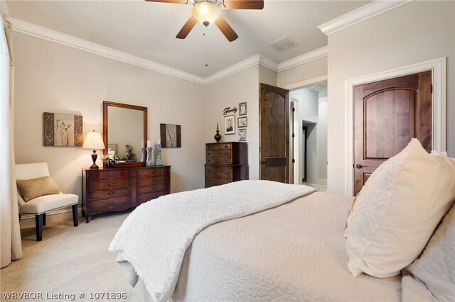 carpeted bedroom with ceiling fan and crown molding