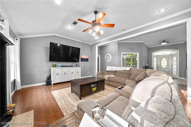 living room with vaulted ceiling, ceiling fan, and crown molding