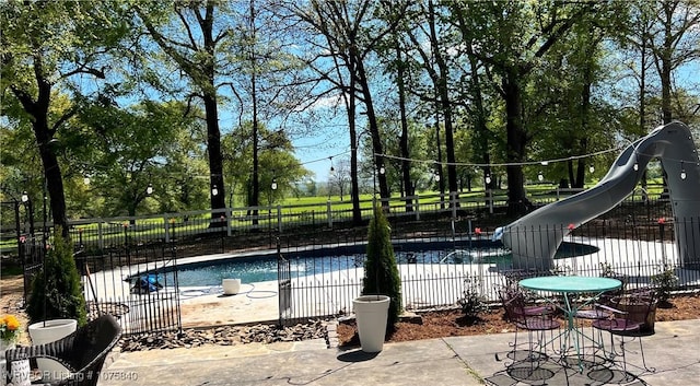 view of swimming pool with a water slide