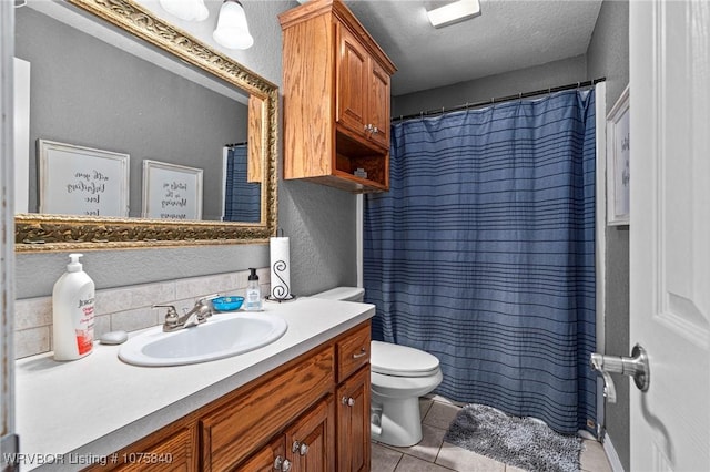 bathroom featuring backsplash, a textured ceiling, vanity, tile patterned flooring, and toilet