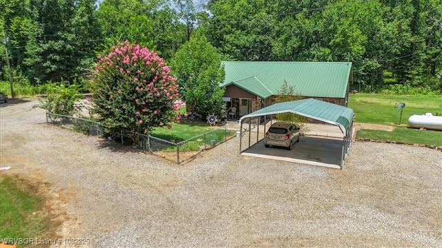3204 W George, Pocola, OK 74902 - view of front of home featuring a detached carport, gravel driveway, a metal roof, and a front yard