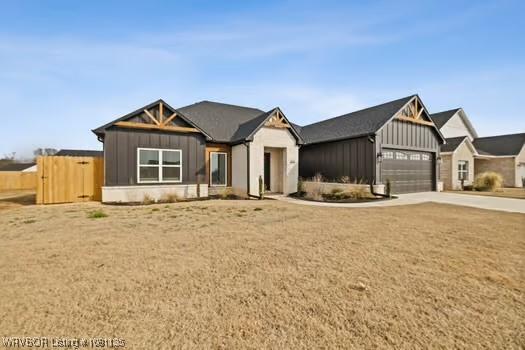 2018 Yellowstone Dr, Barling, AR 72903 - view of front of home with board and batten siding and driveway