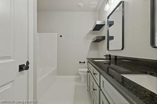 2018 Yellowstone Dr, Barling, AR 72903 - bathroom with toilet, double vanity, and baseboards