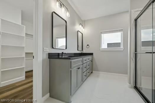 2018 Yellowstone Dr, Barling, AR 72903 - bathroom with double vanity, baseboards, and a shower with shower door
