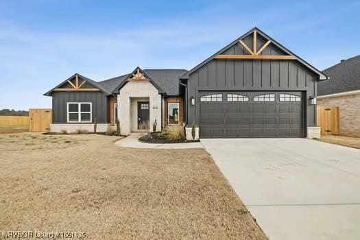 2018 Yellowstone Dr, Barling, AR 72903 - view of front of home featuring board and batten siding, a garage, and driveway