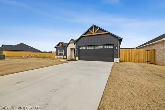 2018 Yellowstone Dr, Barling, AR 72903 - view of front of property featuring a garage, driveway, and board and batten siding