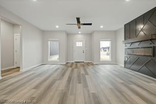 2018 Yellowstone Dr, Barling, AR 72903 - unfurnished living room with baseboards, recessed lighting, light wood-style flooring, and a ceiling fan