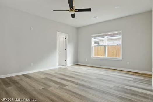 2018 Yellowstone Dr, Barling, AR 72903 - spare room featuring a ceiling fan, wood finished floors, and baseboards